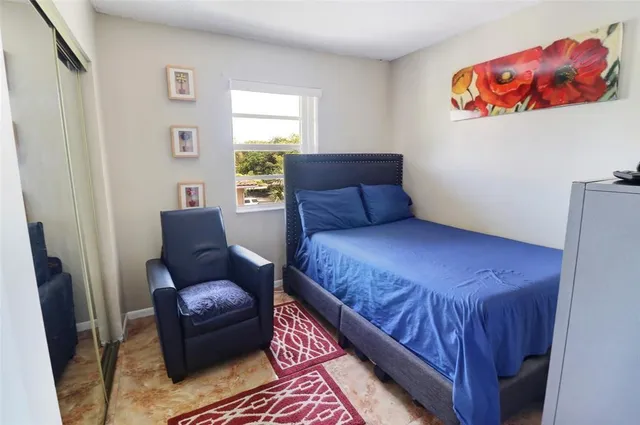a bedroom with a bed and a couch