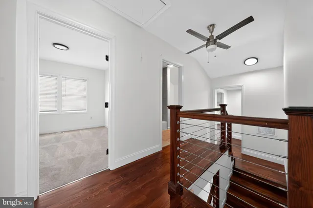 a view of a hallway with wooden floor and entryway