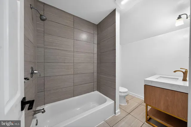 a bathroom with a sink a toilet and bathtub