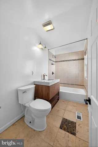 a bathroom with a toilet a sink and bathtub