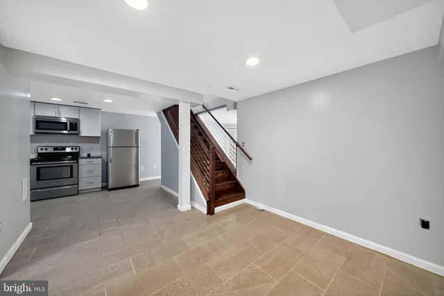 a view of kitchen with cabinets and microwave