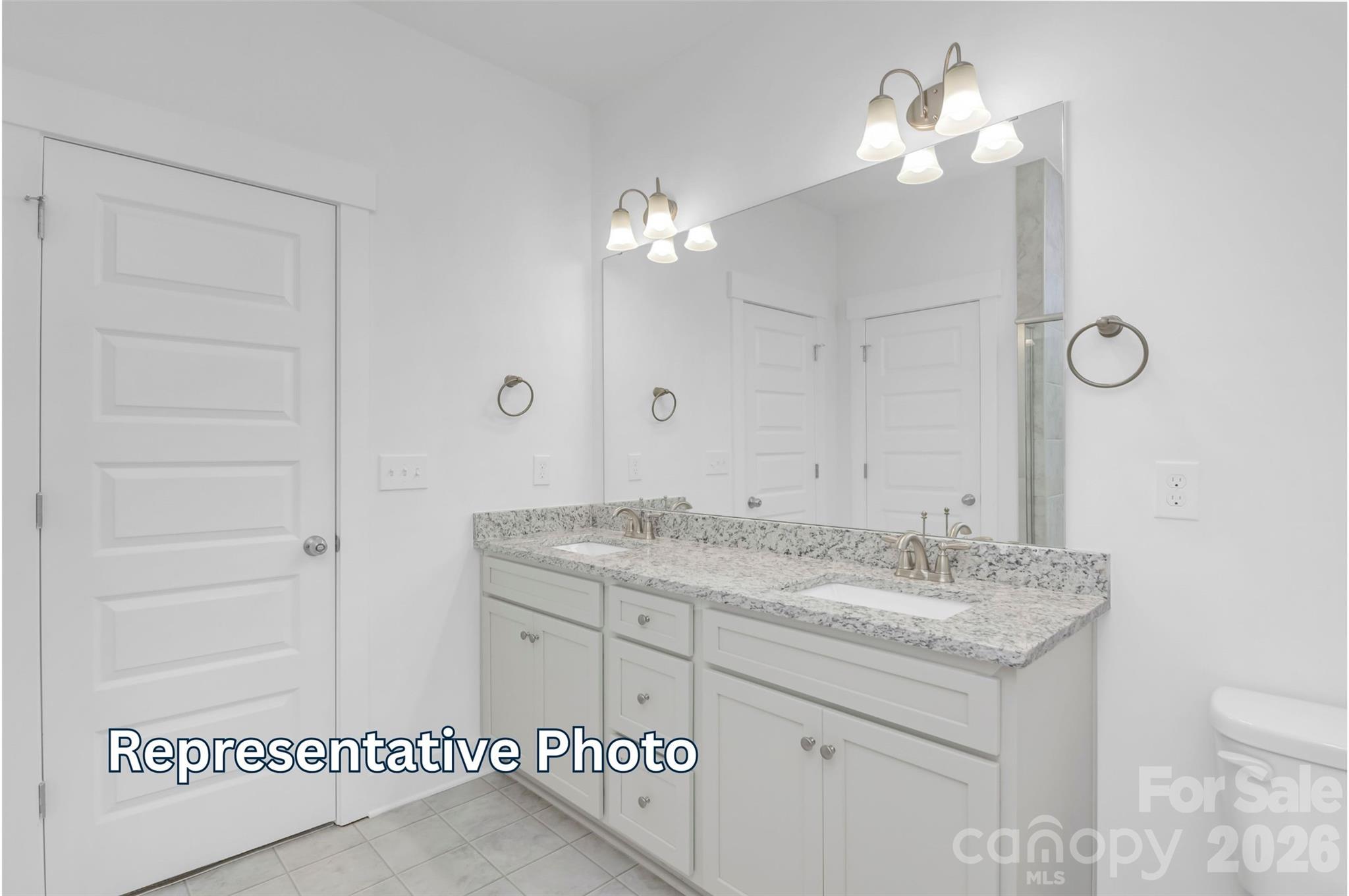 13122 Foxberry Road Charlotte, NC 28213 - Photo 16 of 20 a bathroom with a granite countertop sink a toilet and a mirror
