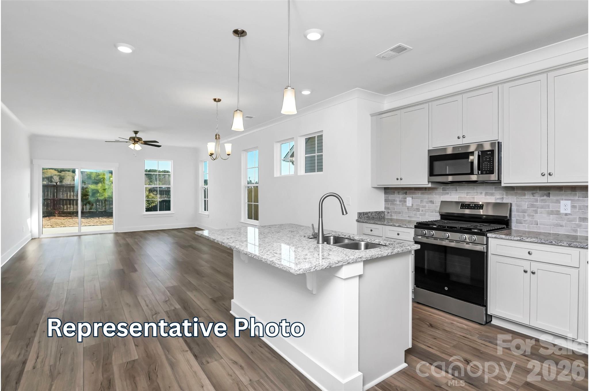 13122 Foxberry Road Charlotte, NC 28213 - Photo 5 of 20 a kitchen with stainless steel appliances granite countertop a sink a stove top oven a counter space and cabinets