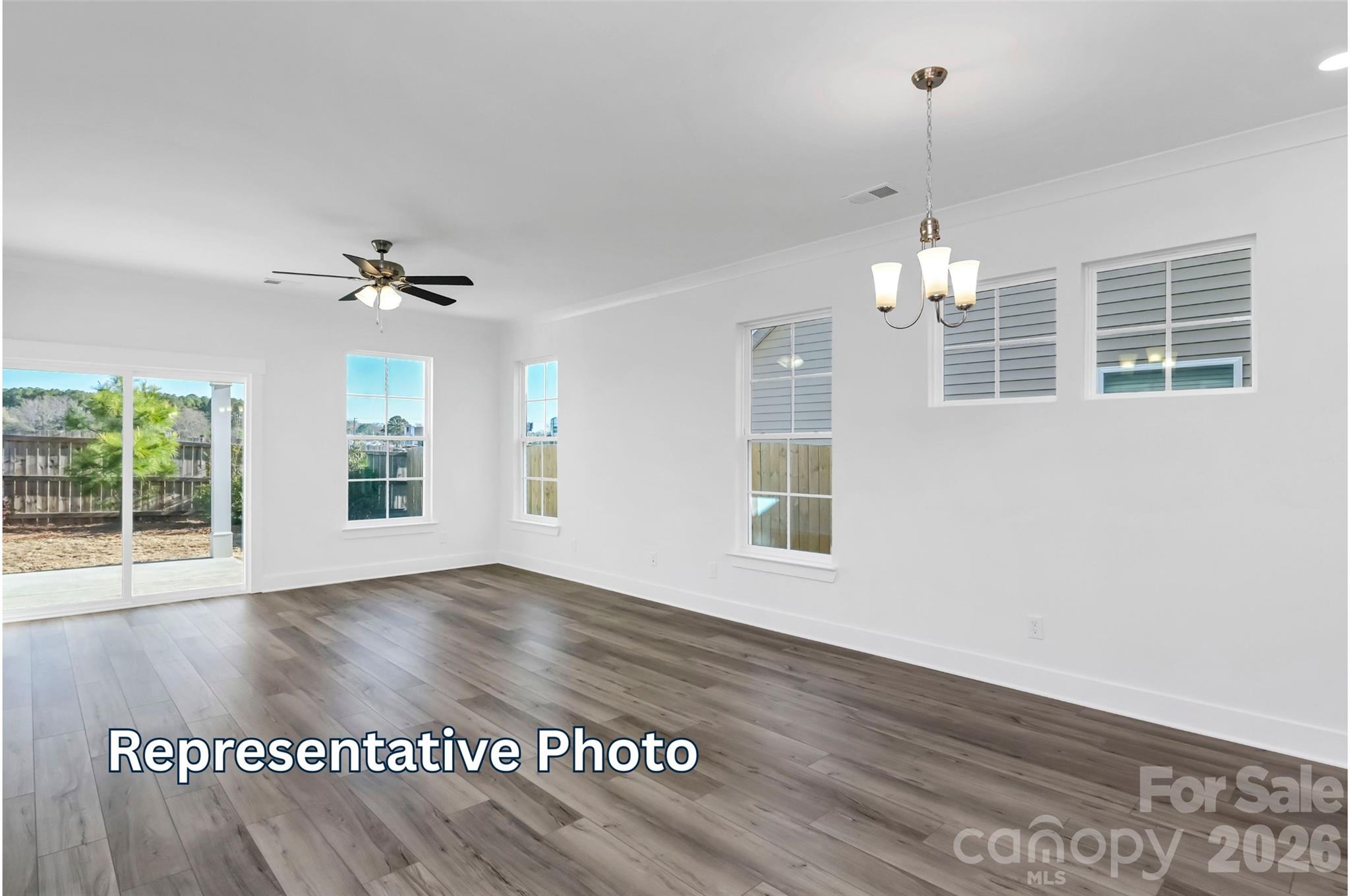 13122 Foxberry Road Charlotte, NC 28213 - Photo 9 of 20 a view of an empty room with wooden floor and a window