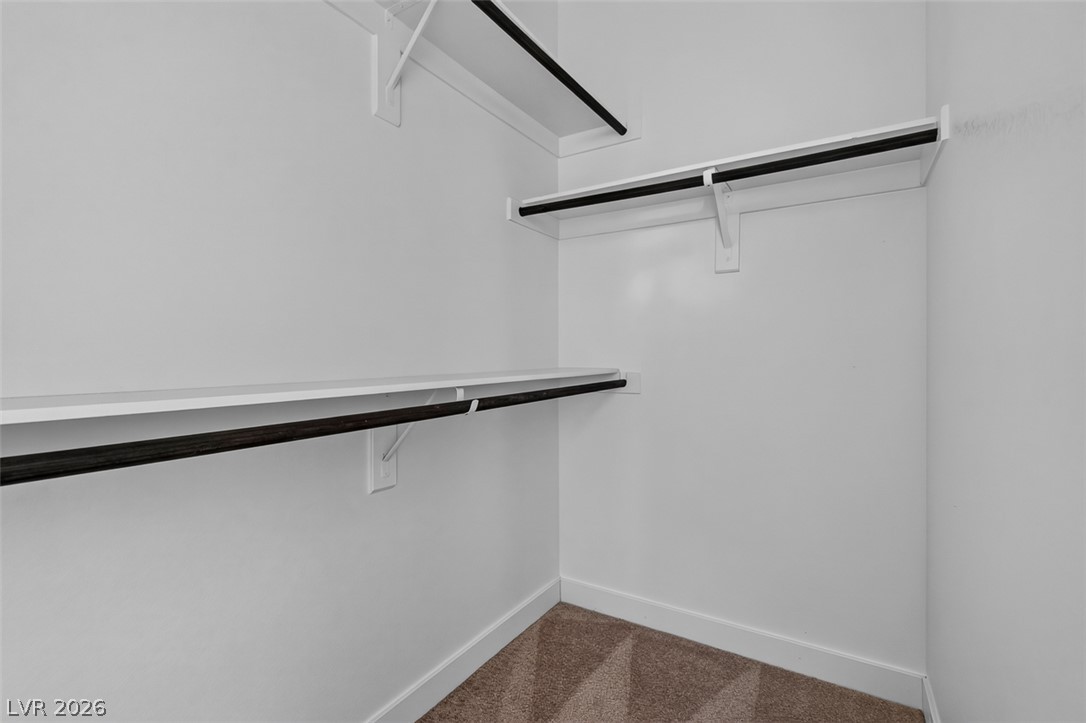 1100 East Sunset Road Henderson, NV 89011 - Photo 24 of 58 Ample shelving and hanging rods provide versatile storage in this well-appointed closet.