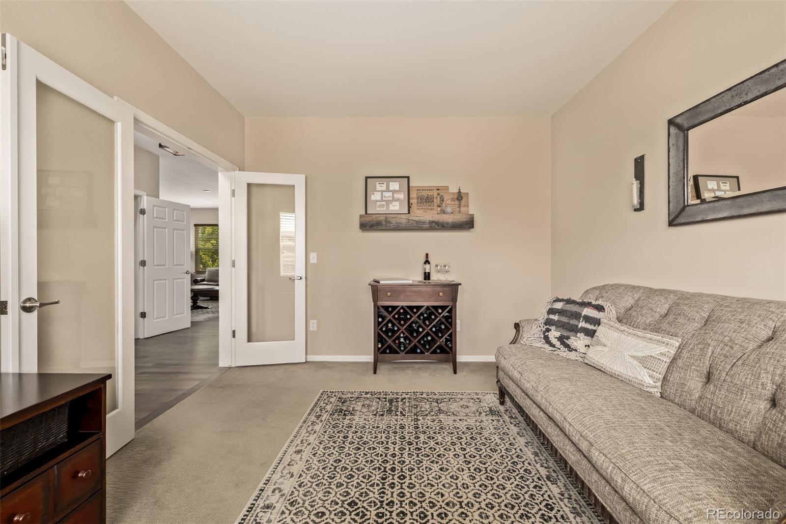 2289 Moss Place Erie, CO 80516 - Photo 14 of 45 a living room with furniture and a rug