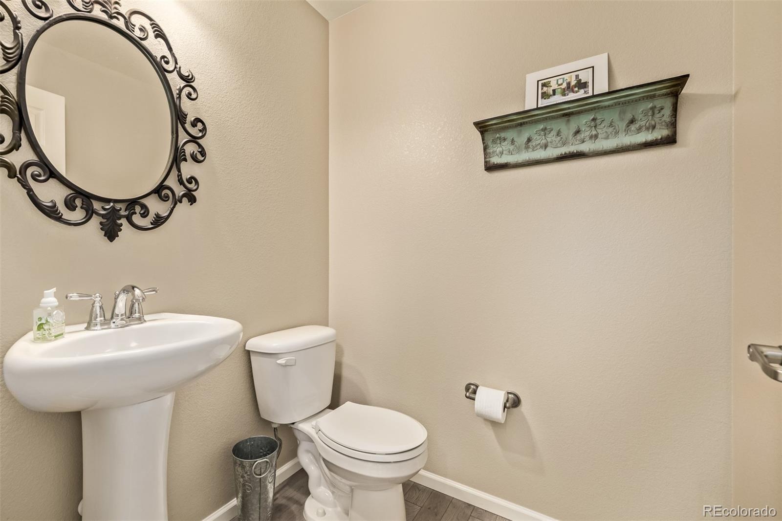 2289 Moss Place Erie, CO 80516 - Photo 15 of 45 a bathroom with a toilet sink and mirror