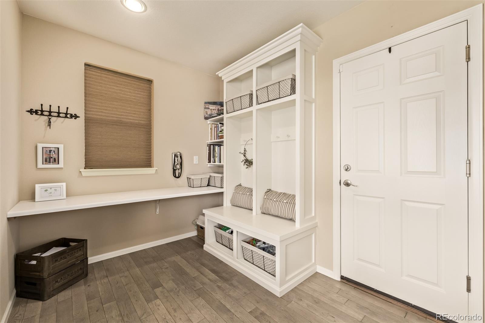 2289 Moss Place Erie, CO 80516 - Photo 16 of 45 a view of kitchen with furniture and wooden floor