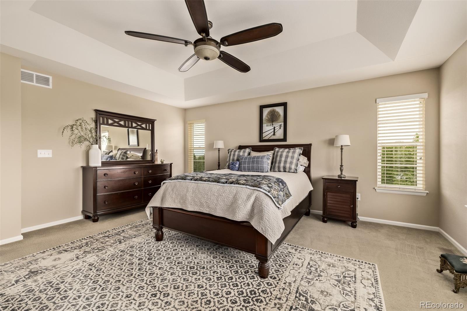 2289 Moss Place Erie, CO 80516 - Photo 19 of 45 a bedroom with a bed a couch and a window