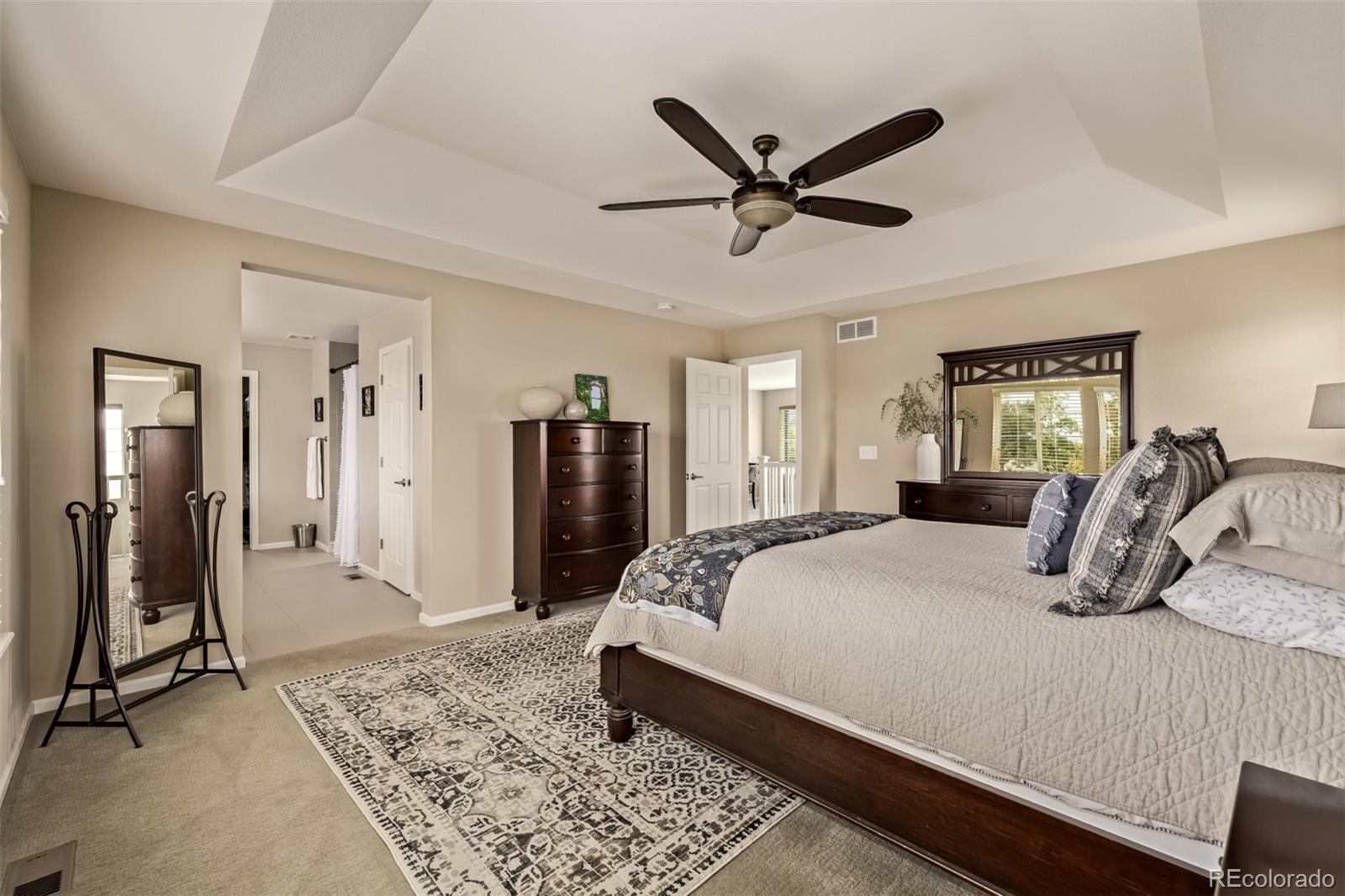 2289 Moss Place Erie, CO 80516 - Photo 20 of 45 a bedroom with a bed and a dresser