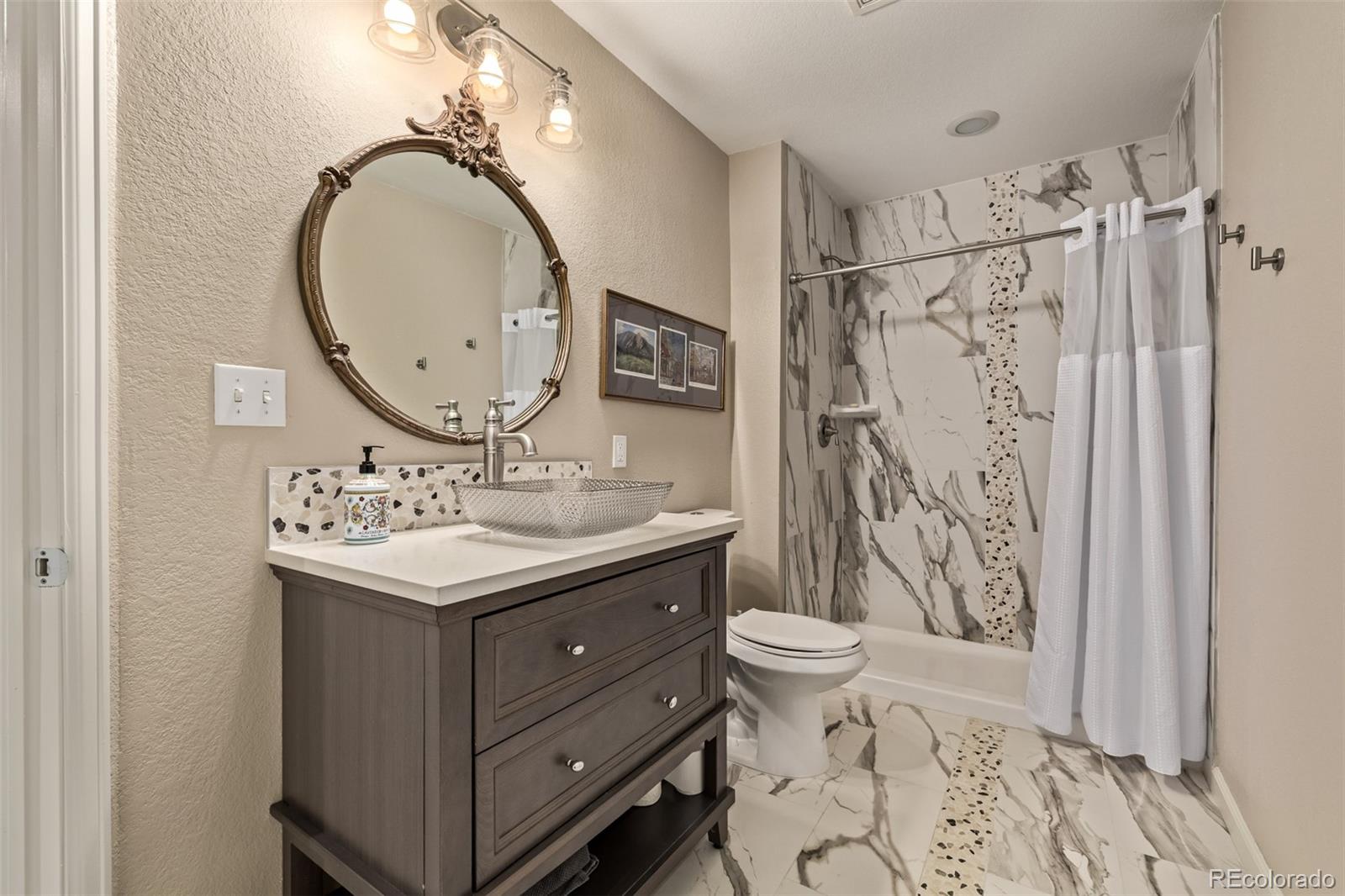 2289 Moss Place Erie, CO 80516 - Photo 30 of 45 a bathroom with a granite countertop sink mirror vanity and toilet
