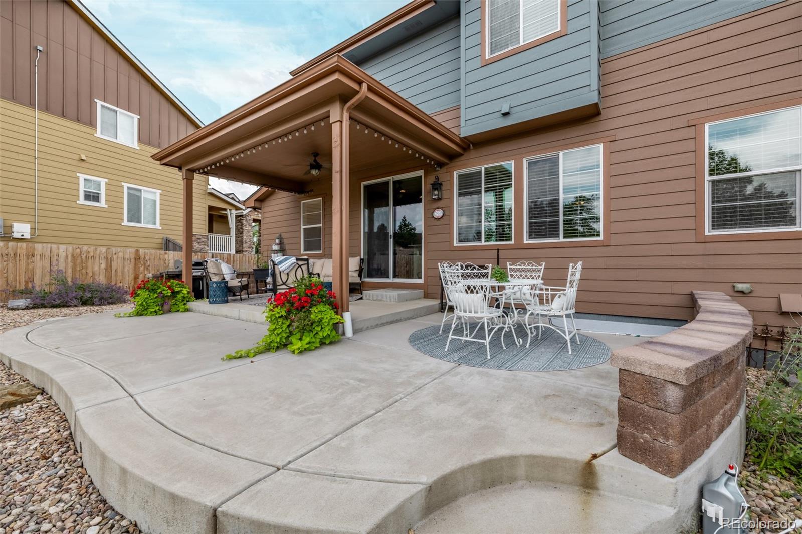2289 Moss Place Erie, CO 80516 - Photo 33 of 45 a view of a patio with table and chairs and potted plants