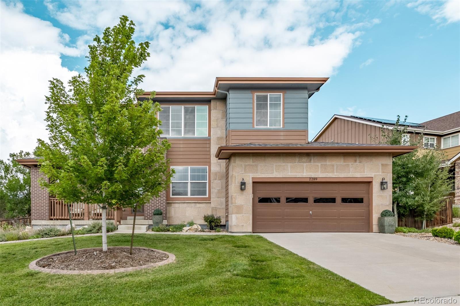2289 Moss Place Erie, CO 80516 - Photo 39 of 45 a front view of a house with a yard and garage
