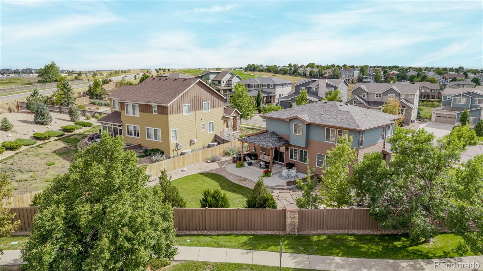 2289 Moss Place Erie, CO 80516 - Photo 44 of 45 an aerial view of a house with a yard and lake view