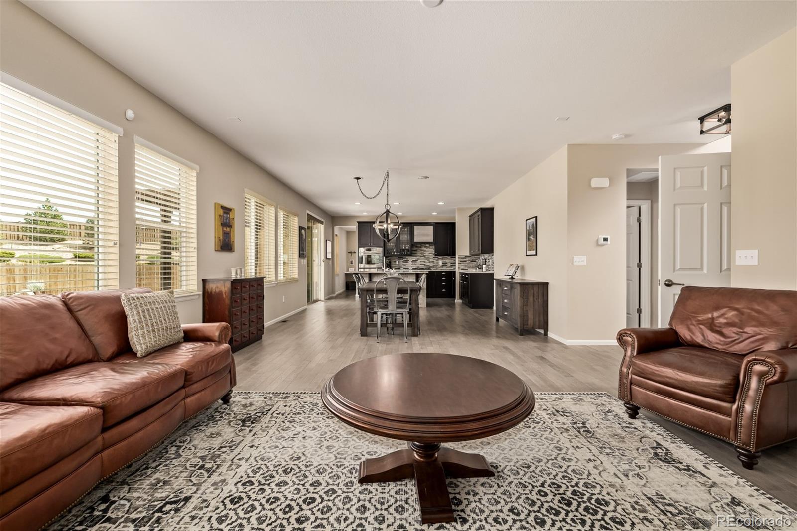 2289 Moss Place Erie, CO 80516 - Photo 6 of 45 a living room with furniture and a large window