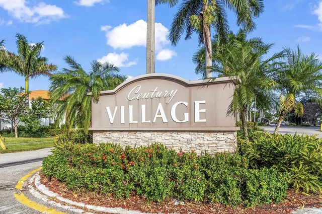 a sign that is sitting in front of flowers