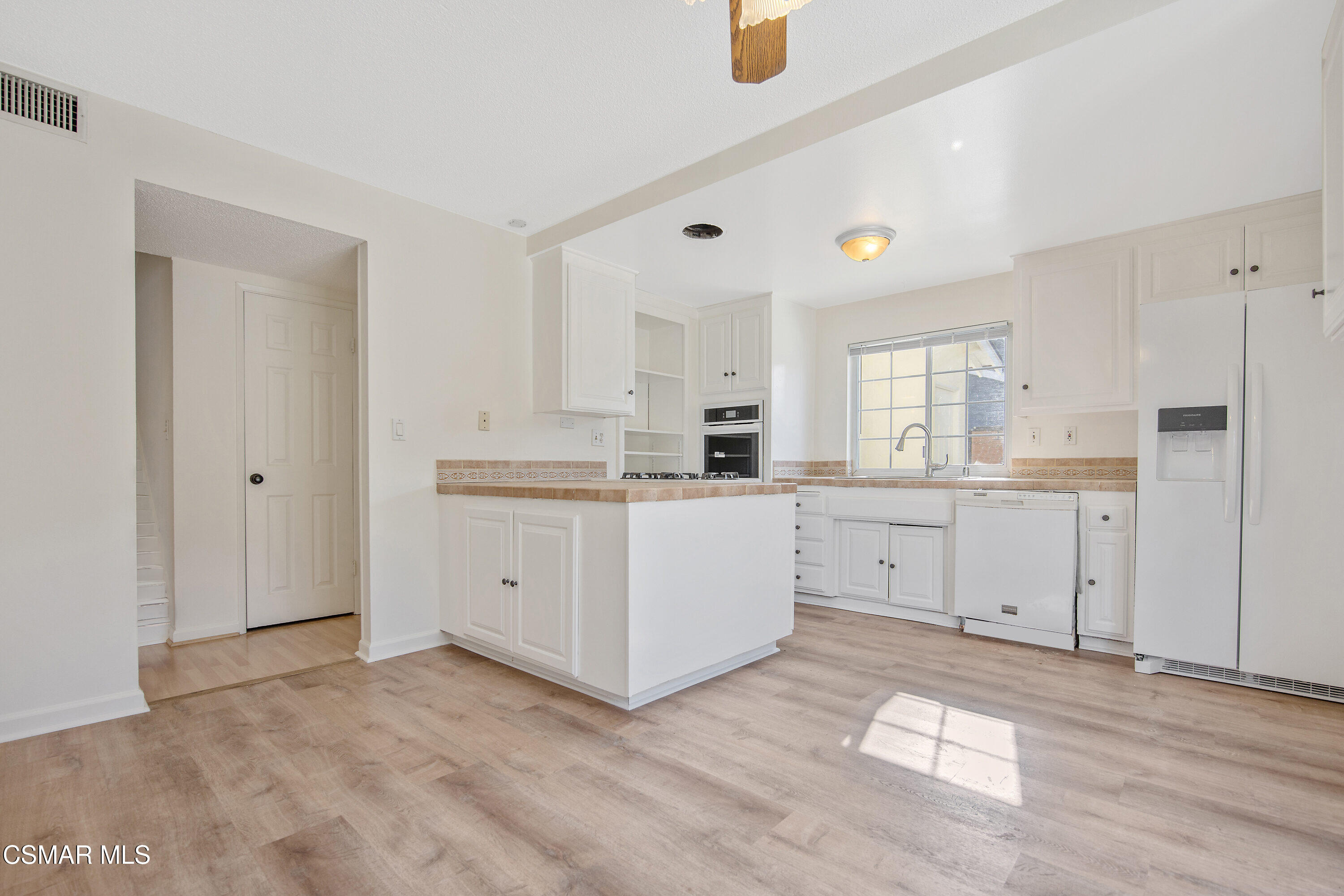 2087 Rhoda Street Simi Valley, CA 93065 - Photo 6 of 22 a view of a kitchen with white cabinets