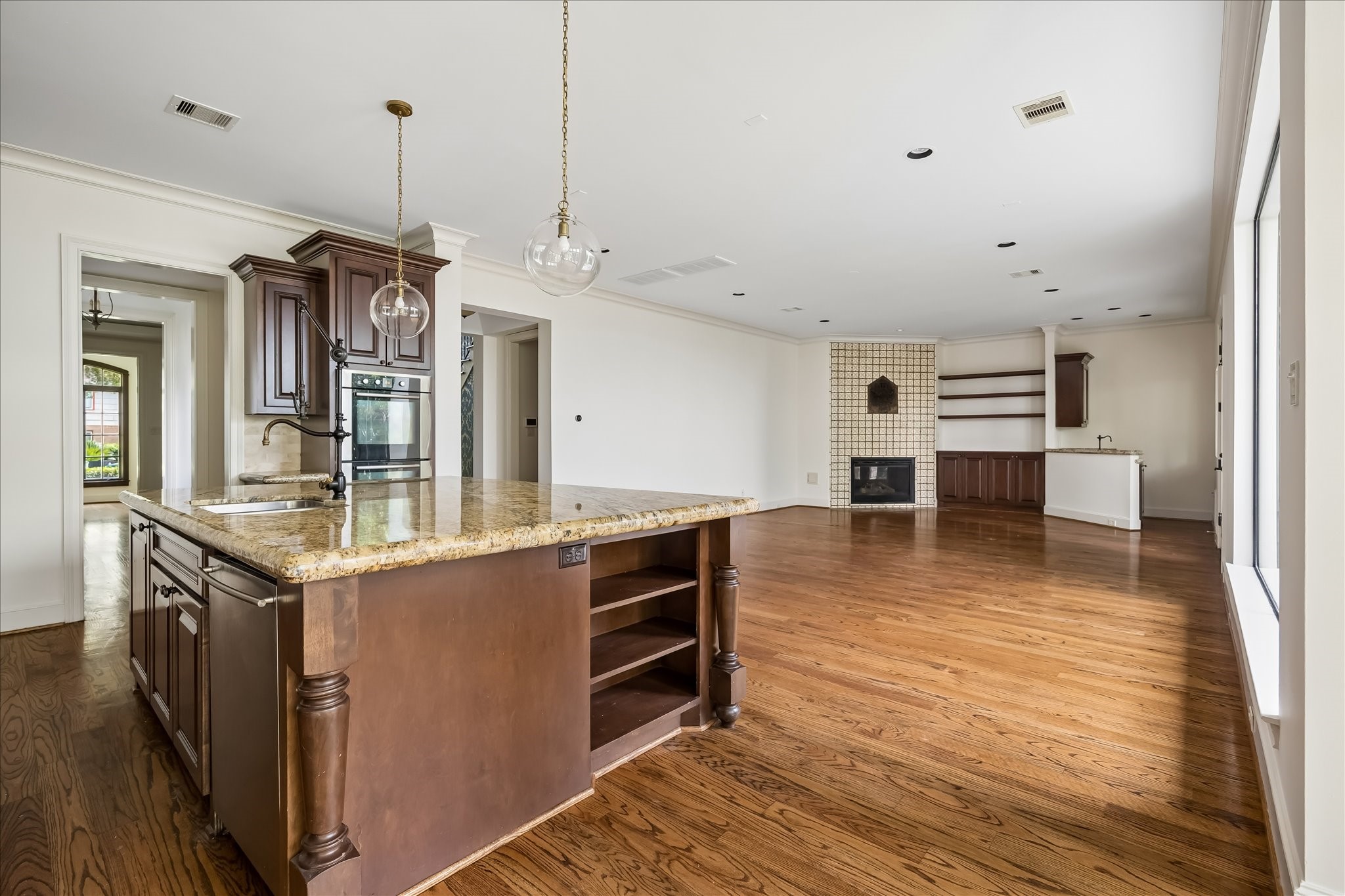 2246 Branard Street Houston, TX 77098 - Photo 15 of 40 Oversized kitchen island anchors the open-concept layout, seamlessly connecting the kitchen and family room.