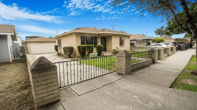 a view of a house with iron fence
