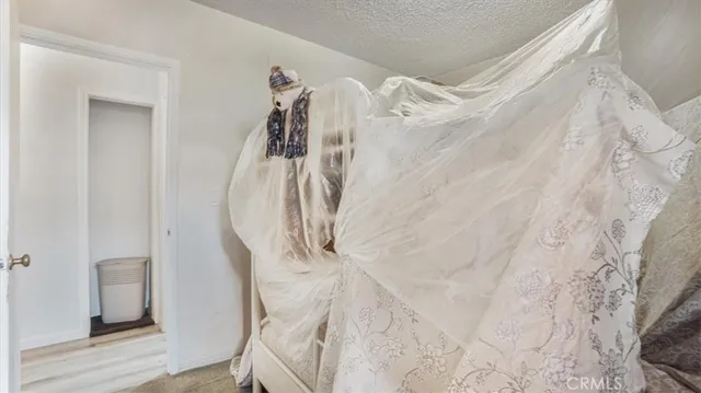 a view of a room with white walls and wooden floor