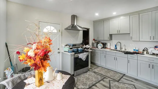 a kitchen with stainless steel appliances granite countertop a sink and a stove