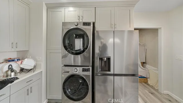 a view of a storage and utility room with washer and dryer
