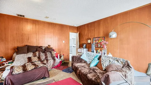a living room with furniture and a painting on the wall