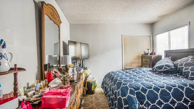 a bedroom with bed and walk in closet