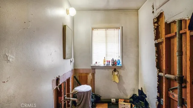a bathroom with a toilet shower and a mirror