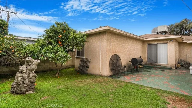 a view of a backyard with a barbeque grill and plants
