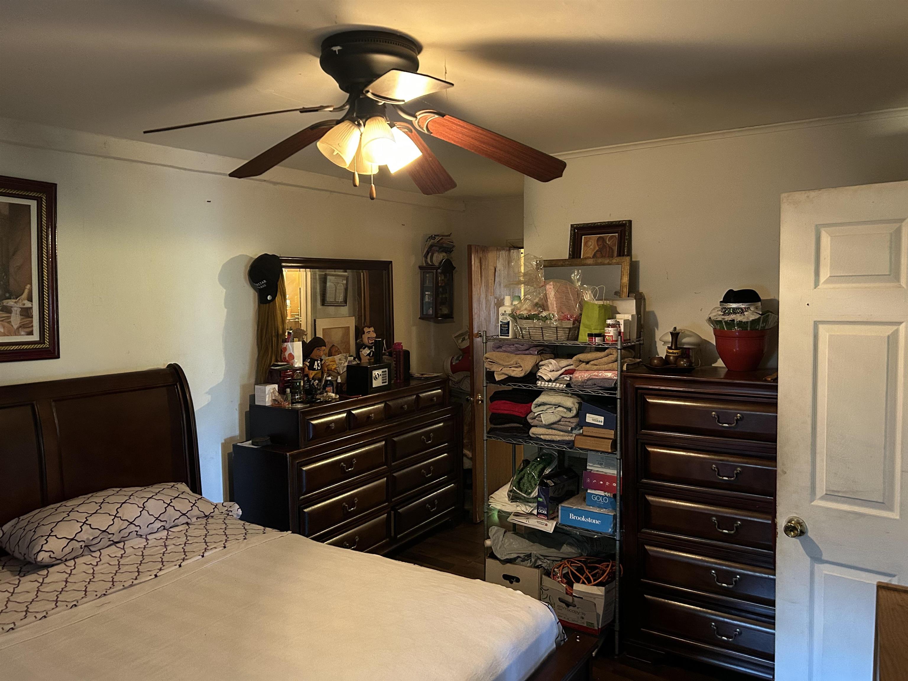3158 Ford Road Memphis, TN 38109 - Photo 12 of 22 a bedroom with a bed and a chandelier