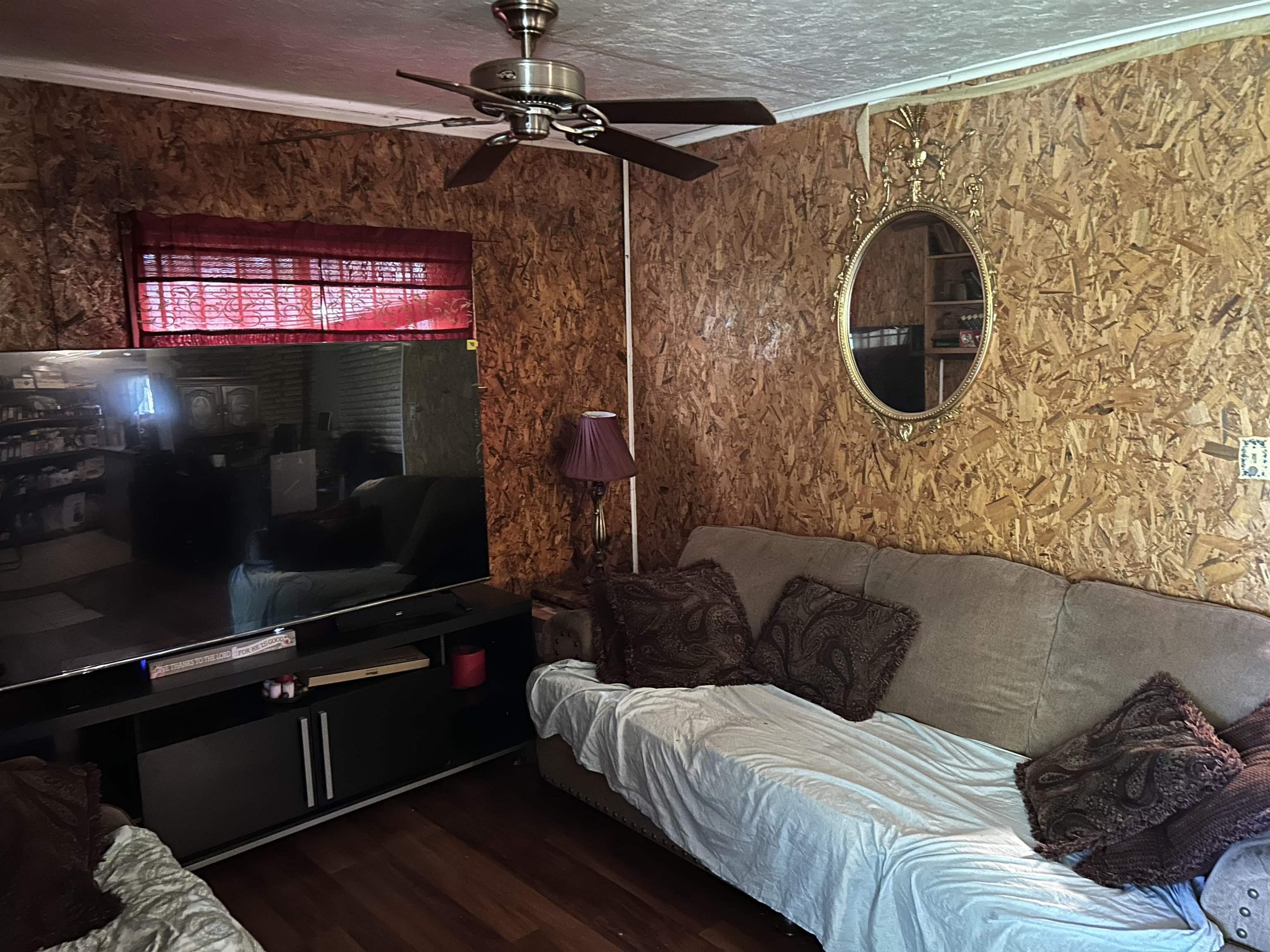 3158 Ford Road Memphis, TN 38109 - Photo 18 of 22 a living room with a bed and a mirror