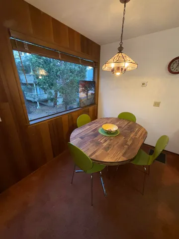 a view of a dining room with furniture wooden floor and chandelier