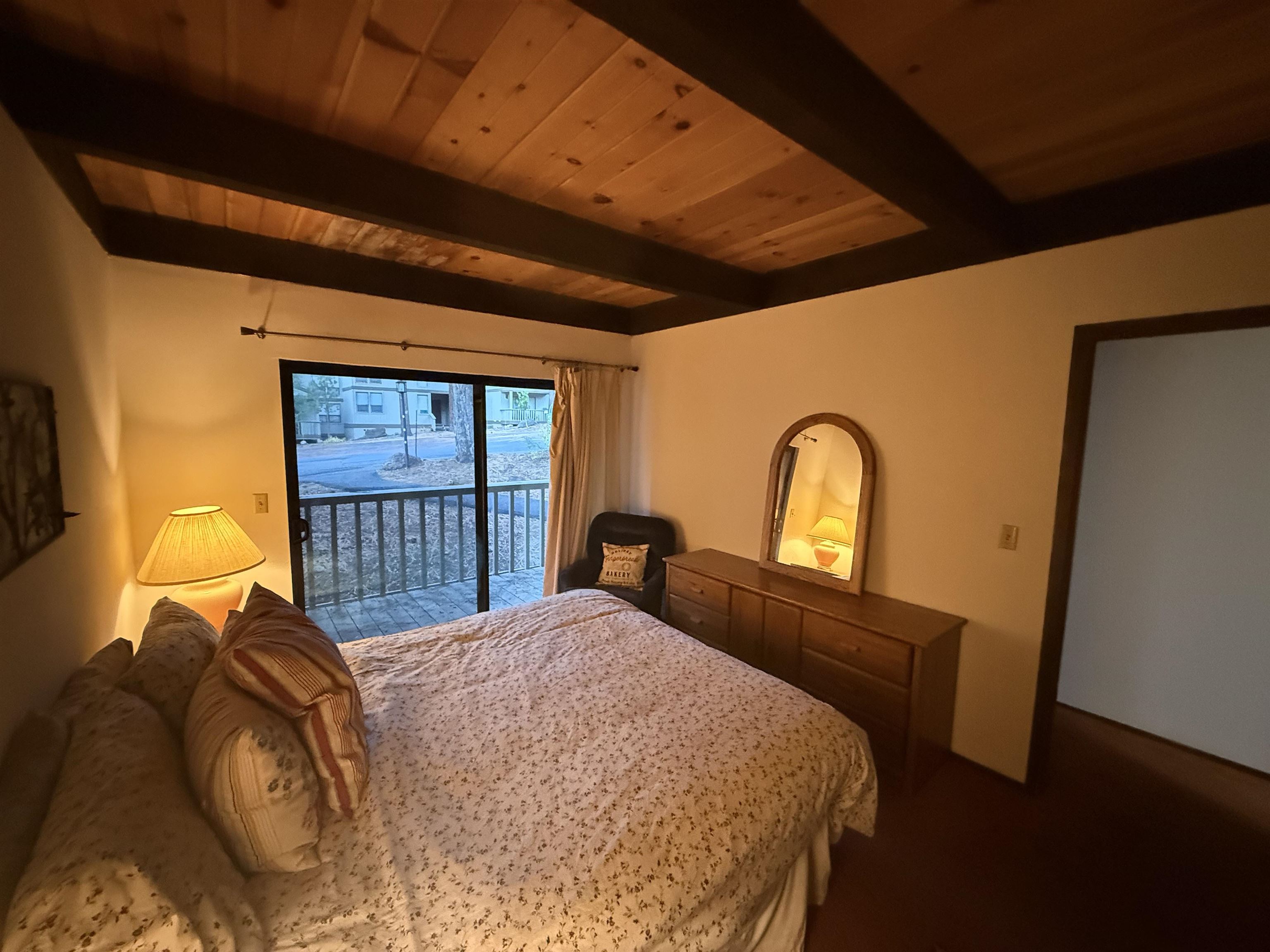 1001 Commonwealth Drive, Unit 97 Kings Beach, CA 96143 - Photo 12 of 28 a bed sitting in a bedroom next to a window