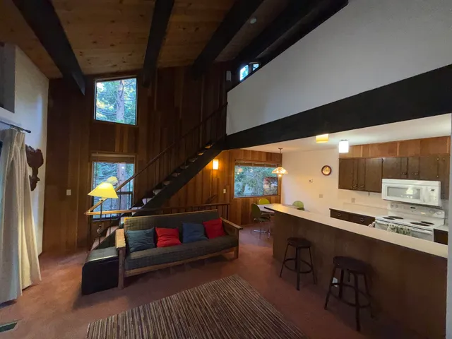 a living room with furniture a air conditioner vent and a window