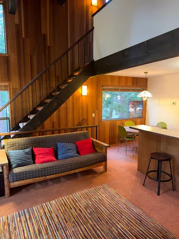 a reading room with wooden floor pool table and chairs