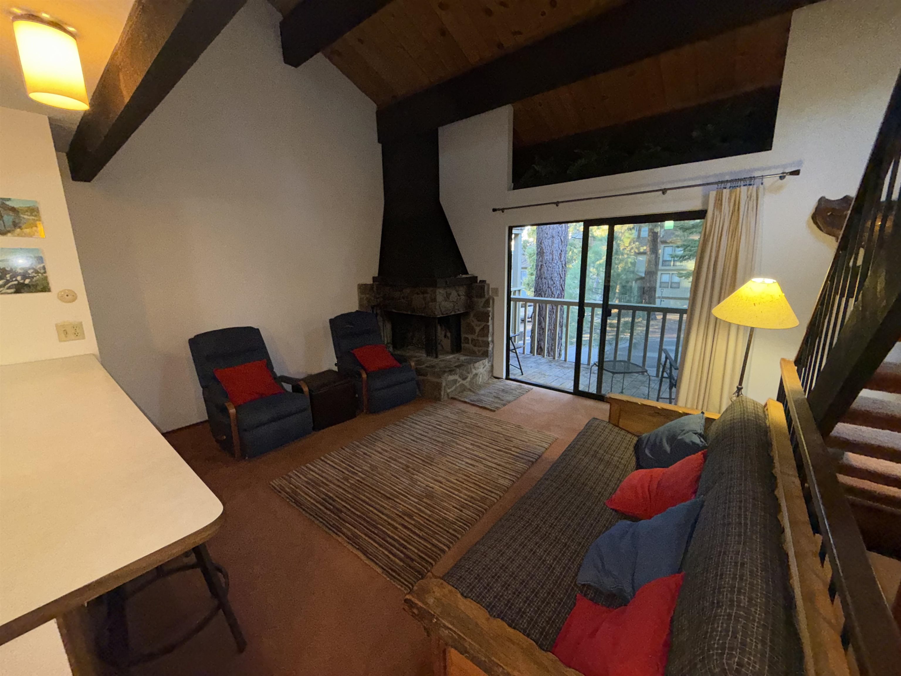 1001 Commonwealth Drive, Unit 97 Kings Beach, CA 96143 - Photo 6 of 28 a living room with furniture fireplace and a flat screen tv