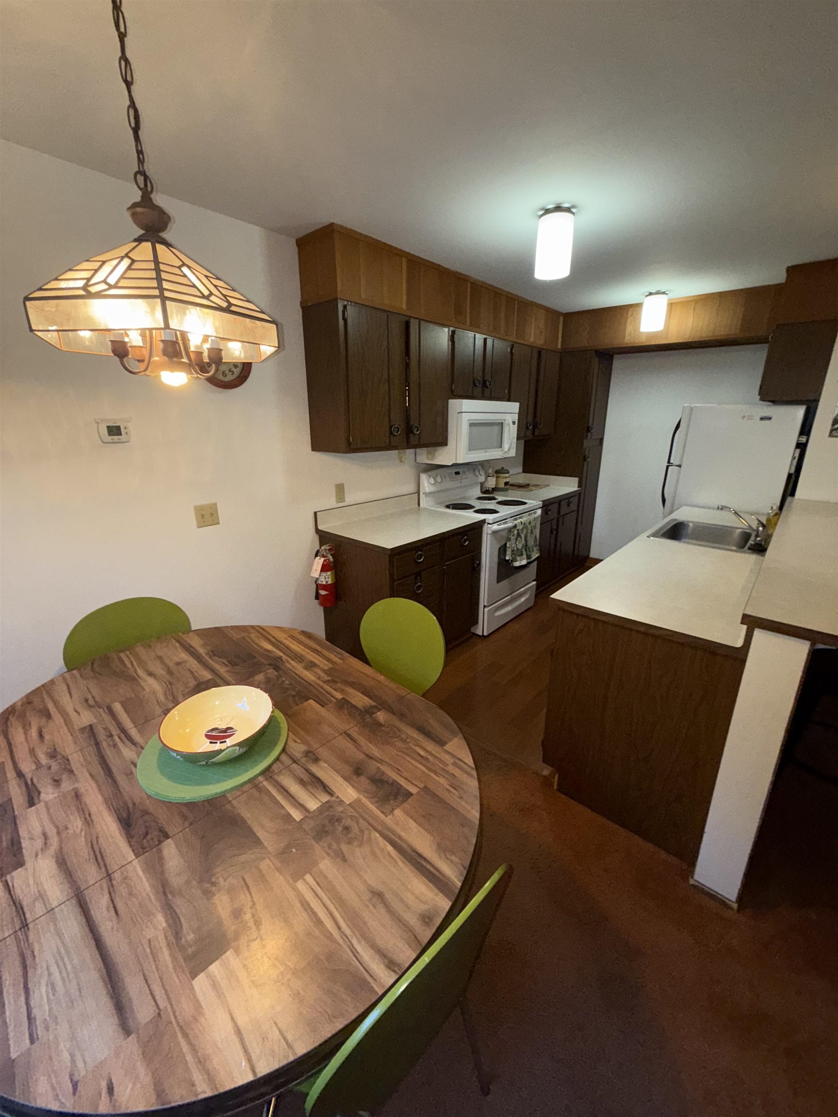 1001 Commonwealth Drive, Unit 97 Kings Beach, CA 96143 - Photo 9 of 28 a kitchen with stainless steel appliances granite countertop a sink a stove a oven a dining table and chairs with wooden floor