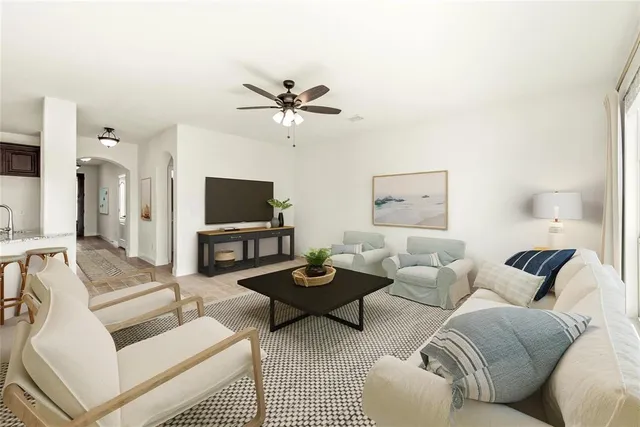 a living room with furniture a rug and a flat screen tv