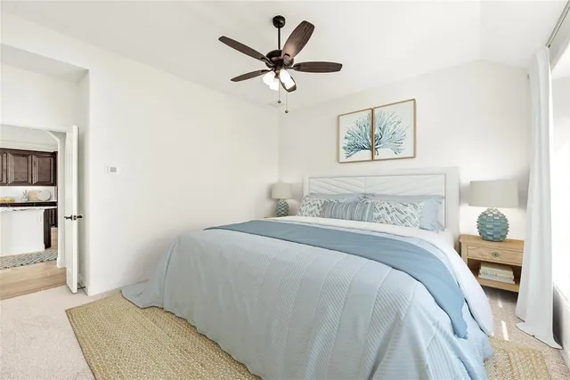 a bedroom with a bed and a painting on the wall