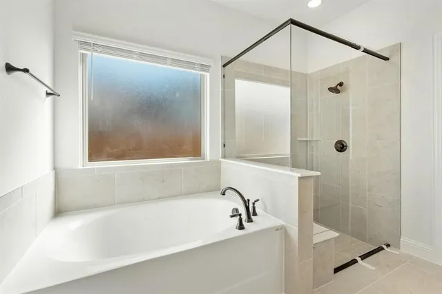 a bathroom with a bathtub and a shower