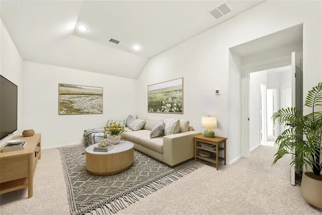 a living room with furniture and a potted plant
