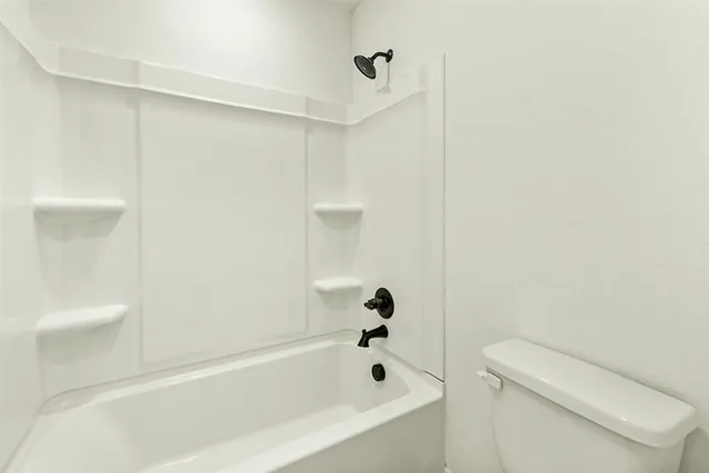 a bathroom with a bathtub and a toilet