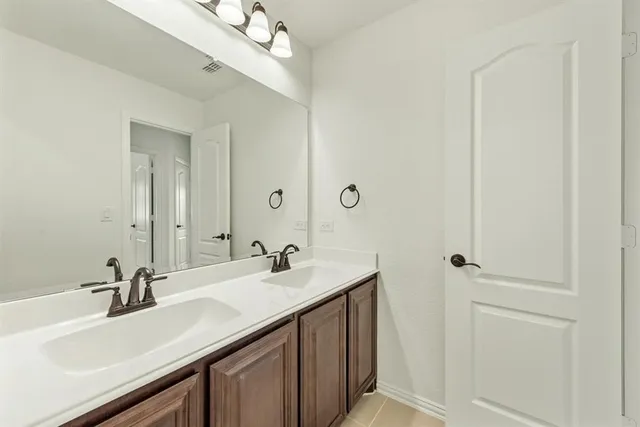 a bathroom with a sink a mirror and vanity