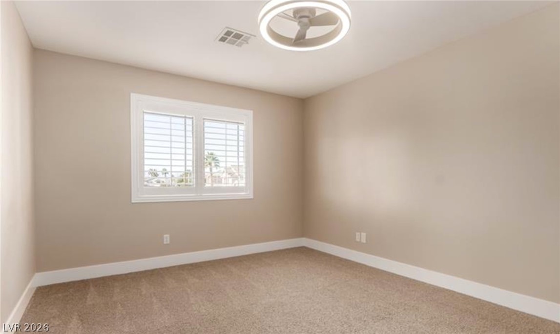 264 Pointe Ranier Avenue Henderson, NV 89012 - Photo 29 of 43 A well-lit bedroom provides a comfortable retreat with plush carpet flooring and natural light.