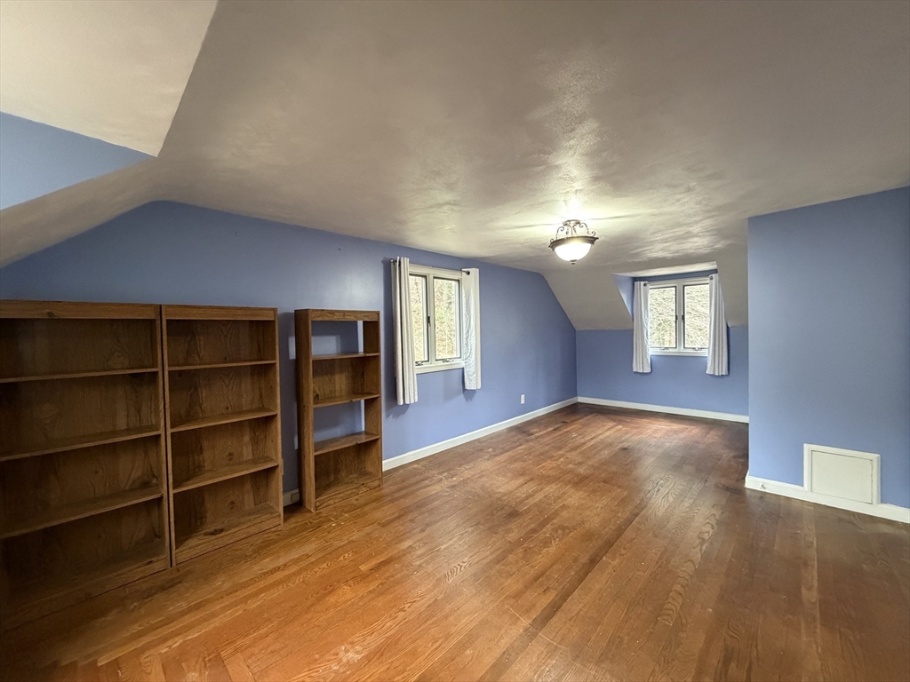 264 Flynt Street Palmer, MA 01069 - Photo 17 of 21 a view of an empty room with a window and wooden floor