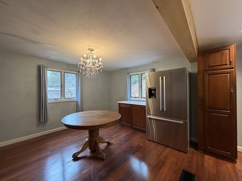 264 Flynt Street Palmer, MA 01069 - Photo 6 of 21 a room with wooden floor potted plant and a chandelier
