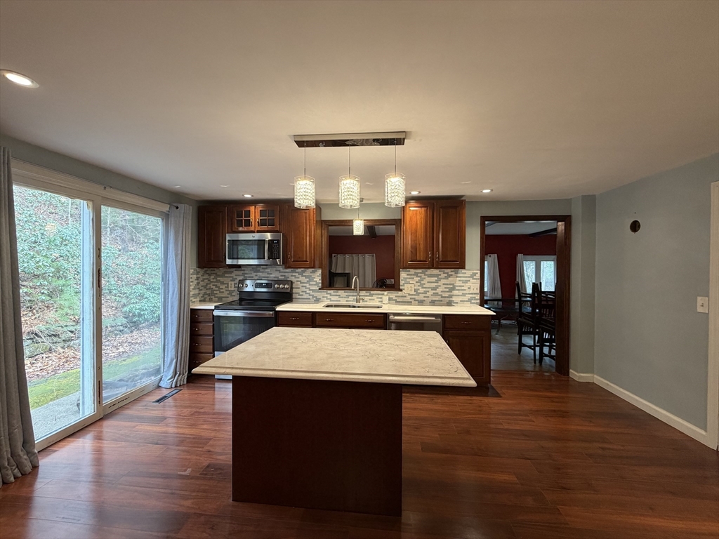 264 Flynt Street Palmer, MA 01069 - Photo 7 of 21 a large kitchen with a table chairs and wooden floor