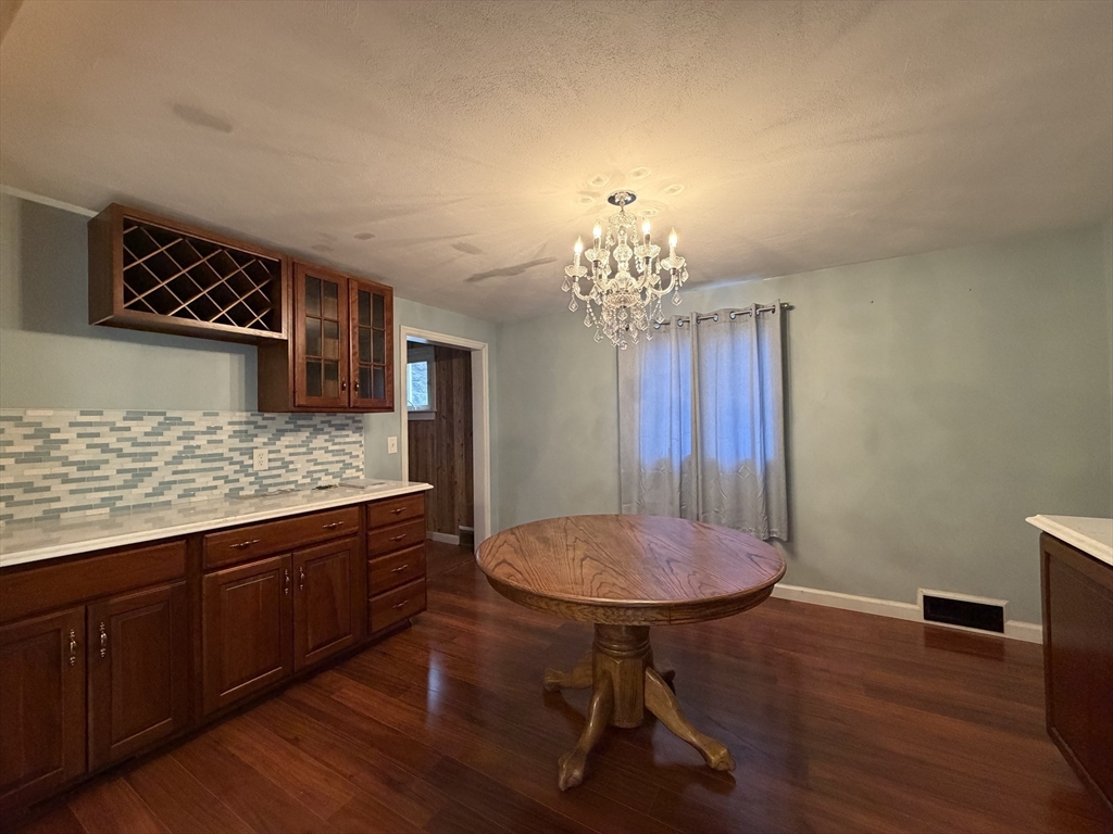 264 Flynt Street Palmer, MA 01069 - Photo 8 of 21 a view of a room with a chandelier wooden floor and table