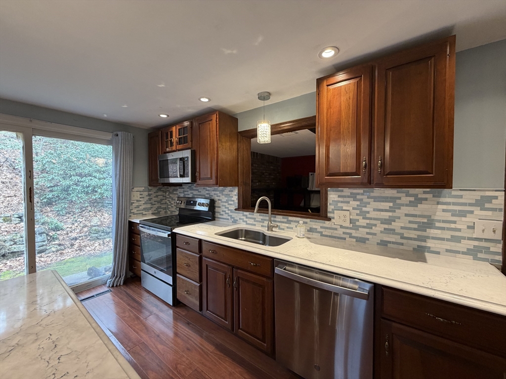264 Flynt Street Palmer, MA 01069 - Photo 9 of 21 a kitchen with stainless steel appliances granite countertop a sink stove and cabinets